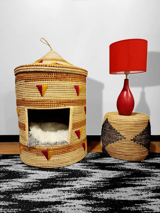 Pemba Eco-Friendly Cat House! - Our hand-woven cathouse basket is a must-have for pet owners. Made 100% natural materials by skilled female artisans, it features a lidded top for a cosy hideaway. With a mix of modern and geometric patterns, it adds a styl