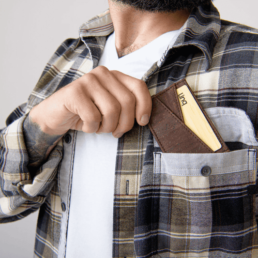 Man placing a sustainable OG Cardholder made of genuine cork into a shirt pocket