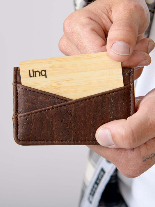 Person holding OG Cardholder made of genuine cork with a card inside.