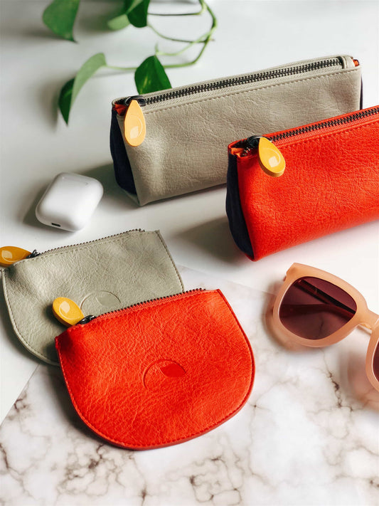 Vegan Makeup Bag & Pouch Set by Union + Coney in trendy colours with sunglasses and plant background