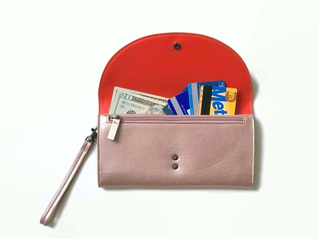 Clark Phone Wallet by Canopy Verde in rose, showing open compartments with cash and cards, made from vegan leather with detachable wrist strap